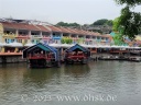 Boote auf dem Singapore River vor bunten Häusern